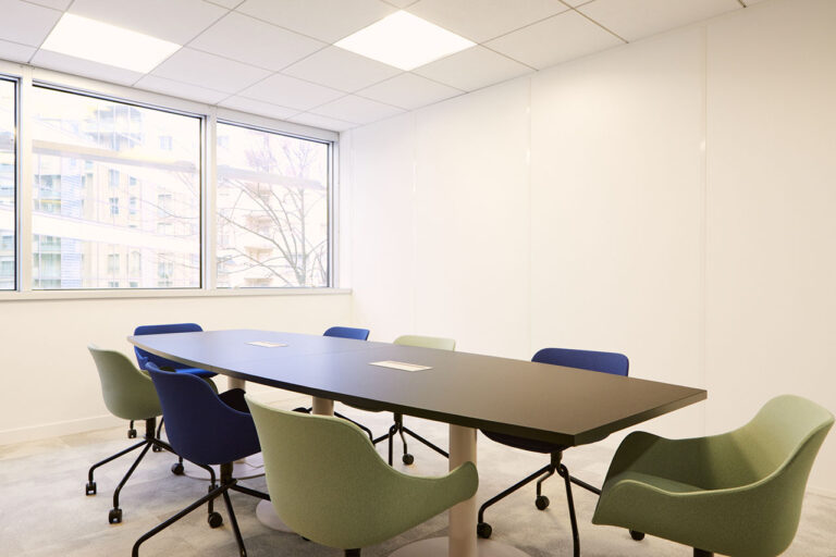 Salle de réunion avec des fauteuils bleu et vert